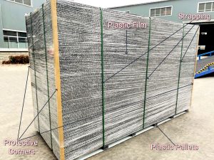 Packaged boards on pallet with strapping, film, and corners.