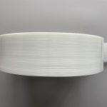 A top-down view image of a roll of glass fiber PE tape.