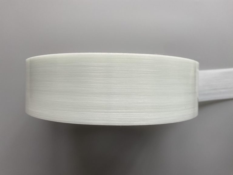A top-down view image of a roll of glass fiber PE tape.