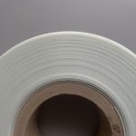 An image of a roll of glass fiber reinforced polyethylene (PE) tape viewed from the side, showcasing its neatly arranged lateral surface.