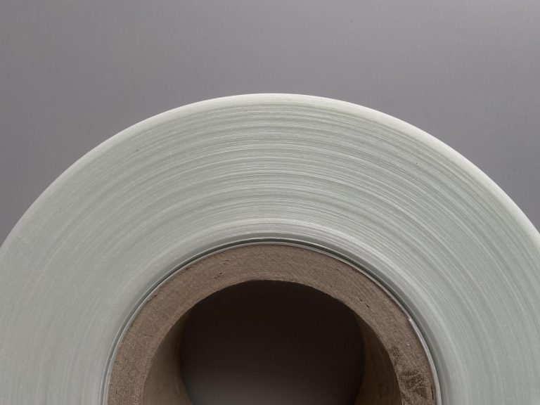 An image of a roll of glass fiber reinforced polyethylene (PE) tape viewed from the side, showcasing its neatly arranged lateral surface.