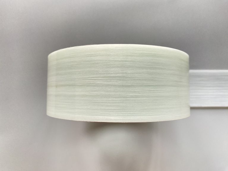 A top-down view image of a roll of glass fiber HDPE tape.