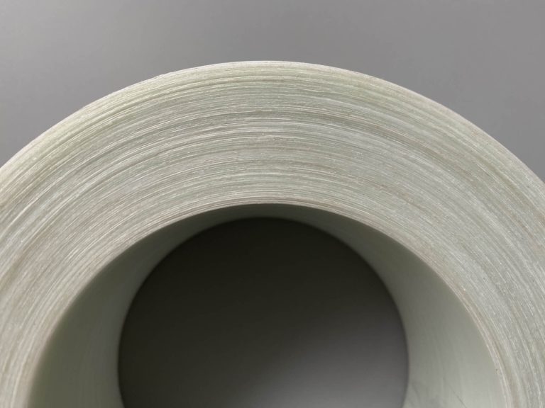 An image of a roll of glass fiber reinforced high density polyethylene (PE) tape viewed from the side, showcasing its neatly arranged lateral surface.