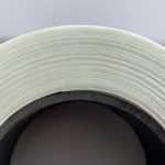 An image of a roll of glass fiber reinforced polypropylene (PP) tape viewed from the side, showcasing its neatly arranged lateral surface.