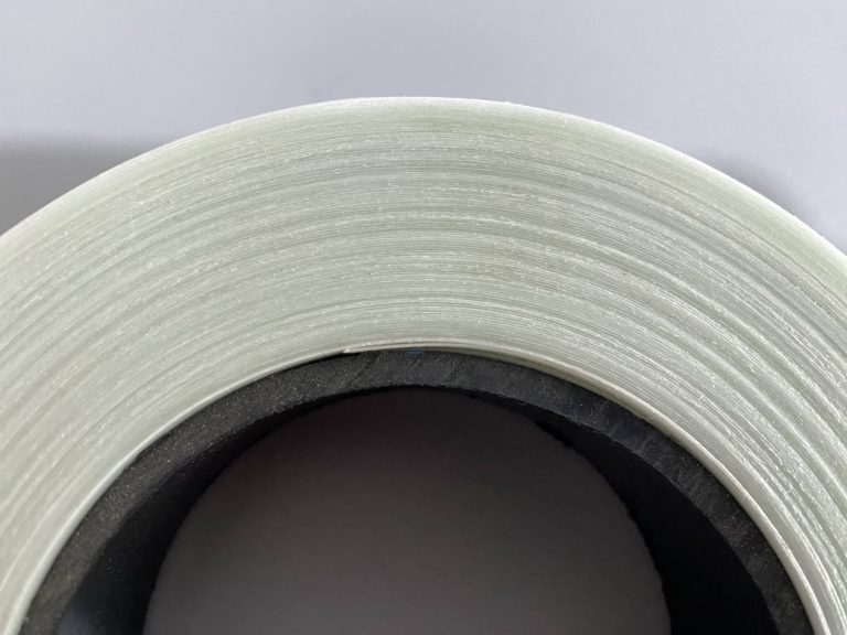 An image of a roll of glass fiber reinforced polypropylene (PP) tape viewed from the side, showcasing its neatly arranged lateral surface.