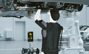 Model underneath a car using the arm exoskeleton X-ble Shoulder for assistance